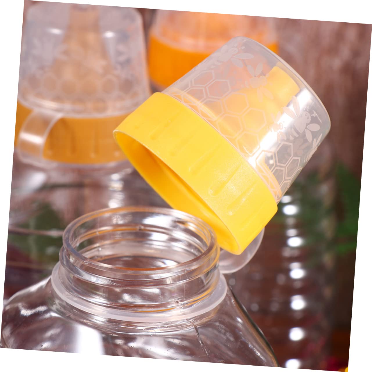 OUNONA 4Pcs Transparent Plastic Honey Bottle with Random Lid Colors Capacity for Honey Jam Bbq Sauce Oil and Ketchup Storage and Dispensing Home