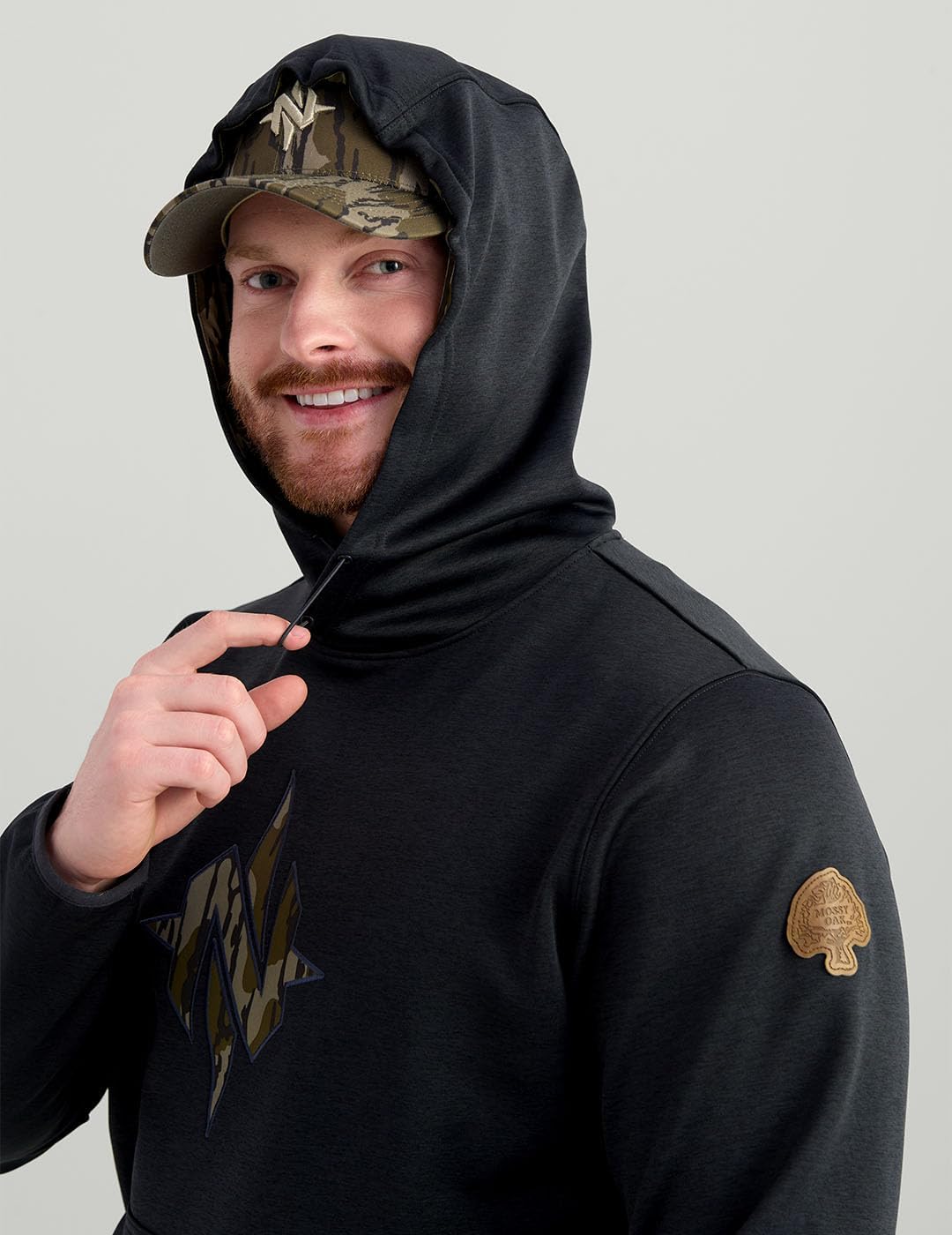 Nomad Men's Standard North Star, Comfortable Midweight Hunting Hoodie with Camo Logo for Everyday and Outdoor Lifestyle, Black/Mossy Oak Bottomland
