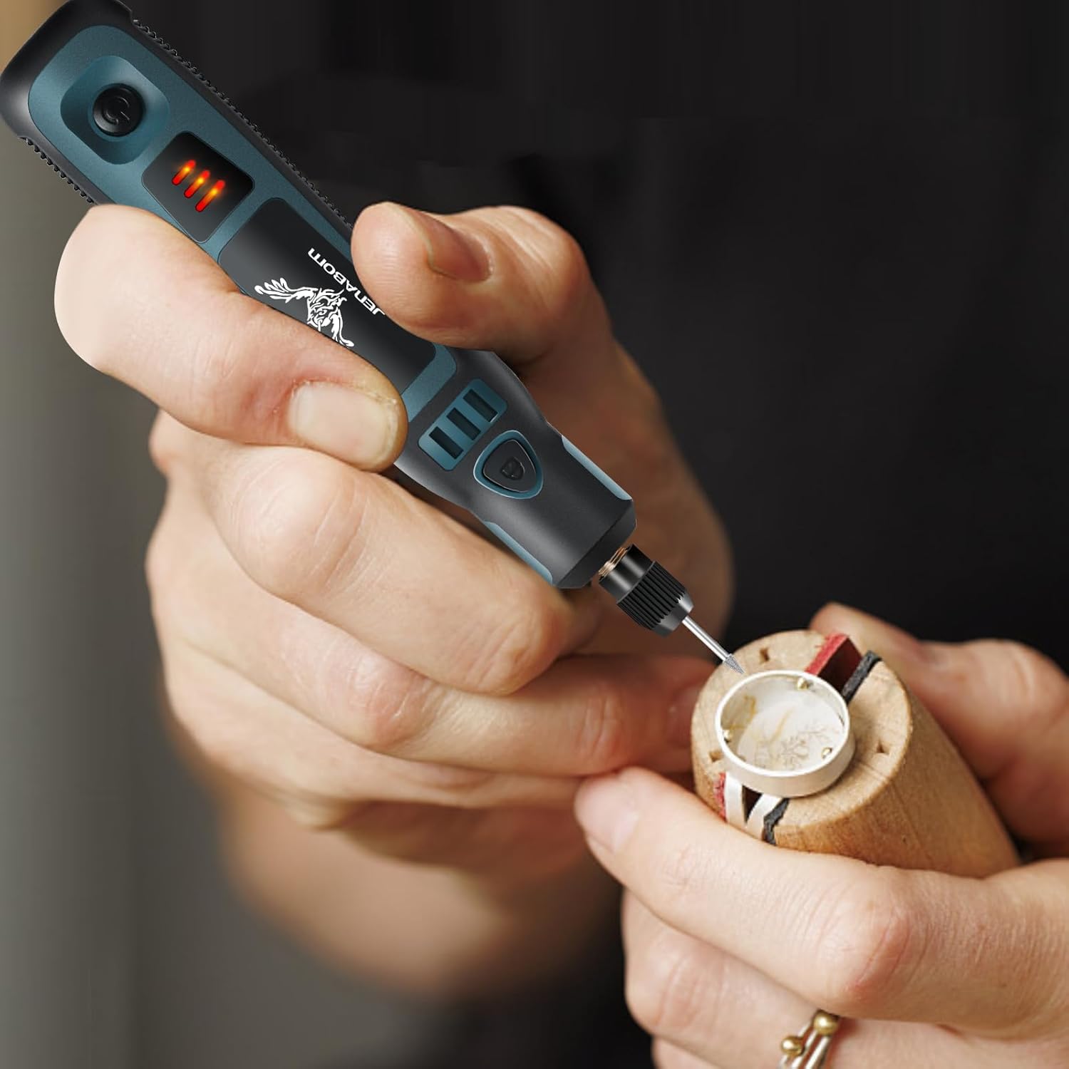 Close-up of a hand using the JENABOM Mini Cordless Rotary Tool for a detailed craft task.