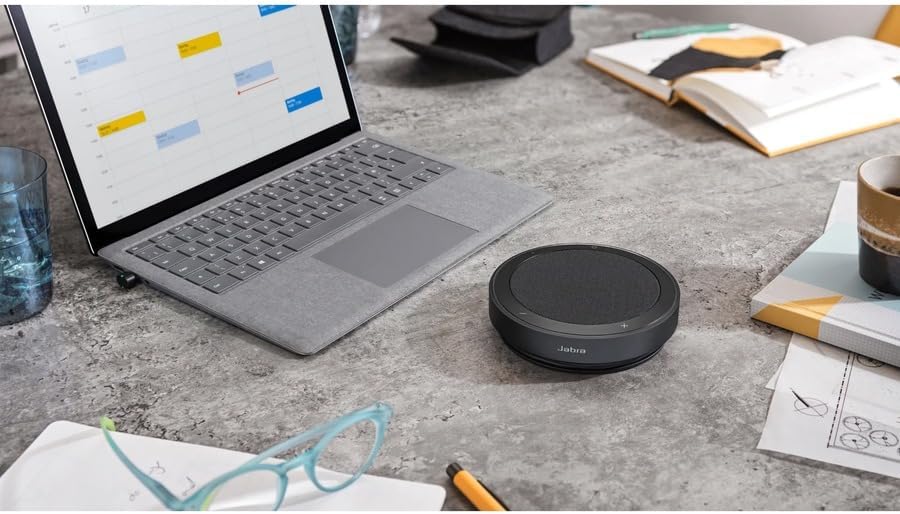 Jabra Speak2 75 on a desk with a laptop