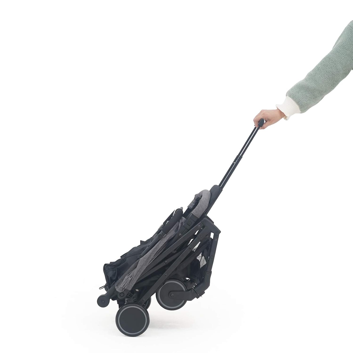 Pamo babe Compact Baby Stroller being pulled like luggage