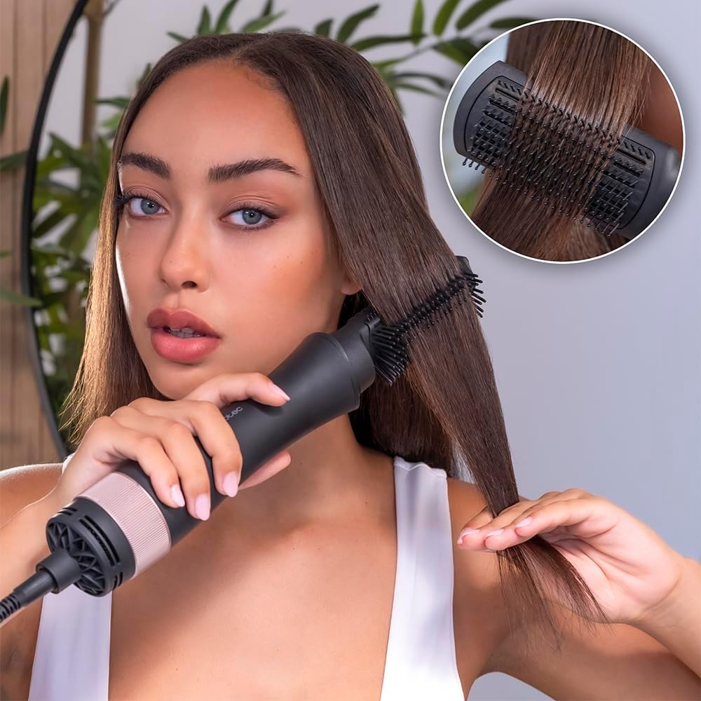 User styling hair with a paddle brush attachment for detangling and smoothing