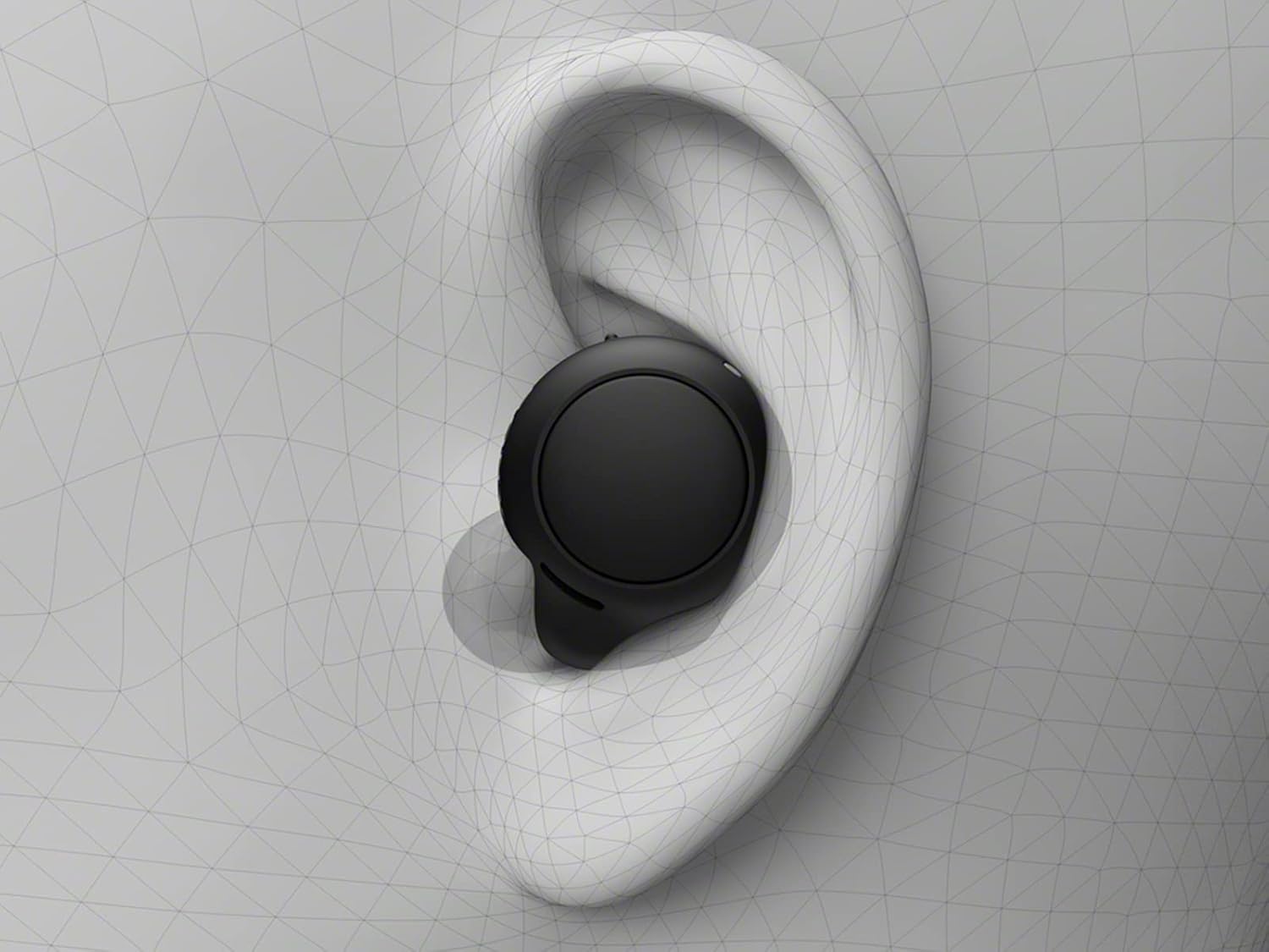 Close-up of a black Sony WF-C500 earbud correctly placed in a human ear