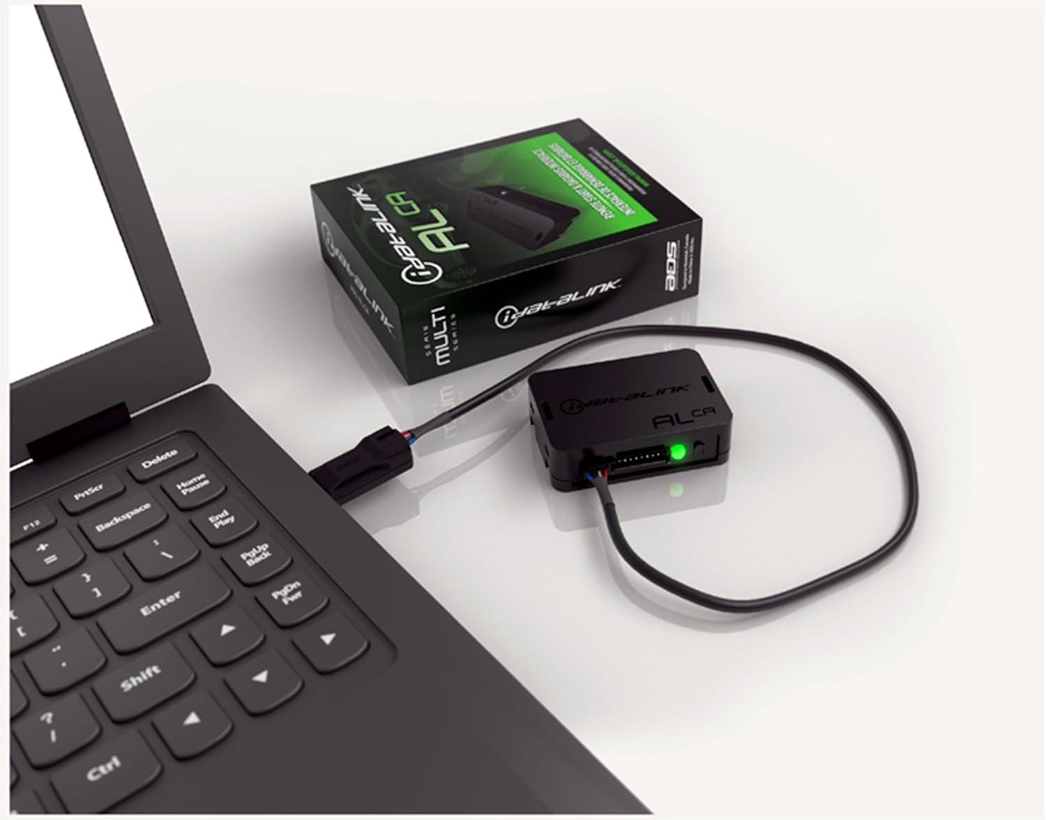 iDatalink ADS-ALCA module connected to a laptop via USB for programming.