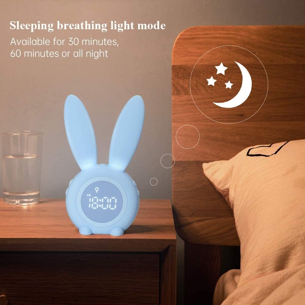 Rabbit alarm clock on a bedside table with its ears glowing as a night light