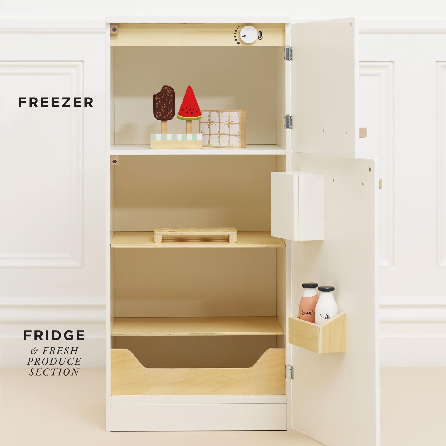 Interior view of the Le Toy Van Wooden Fridge Freezer with both doors open, revealing shelves, a produce drawer, and door compartments for play food items.