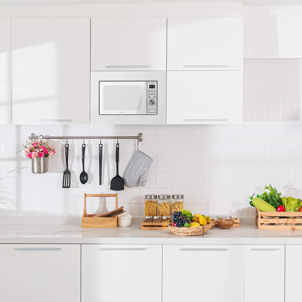 The Cecotec GrandHeat 2050 Built-In Microwave installed in a modern white kitchen, integrated into the upper cabinetry.