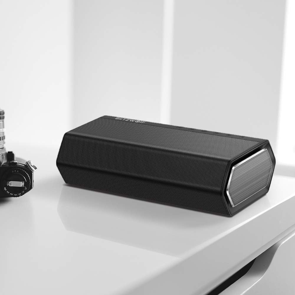 BlitzWolf BW-AS2 speaker on a desk next to a camera