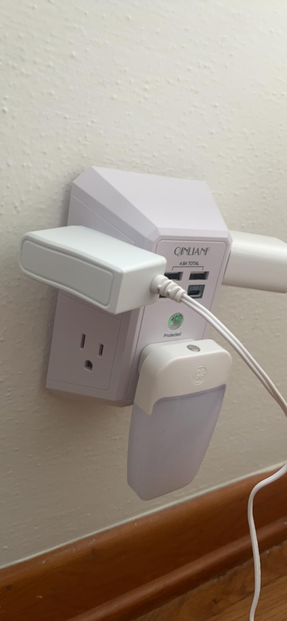 QINLIANF outlet extender in use on wall with three plugs connected