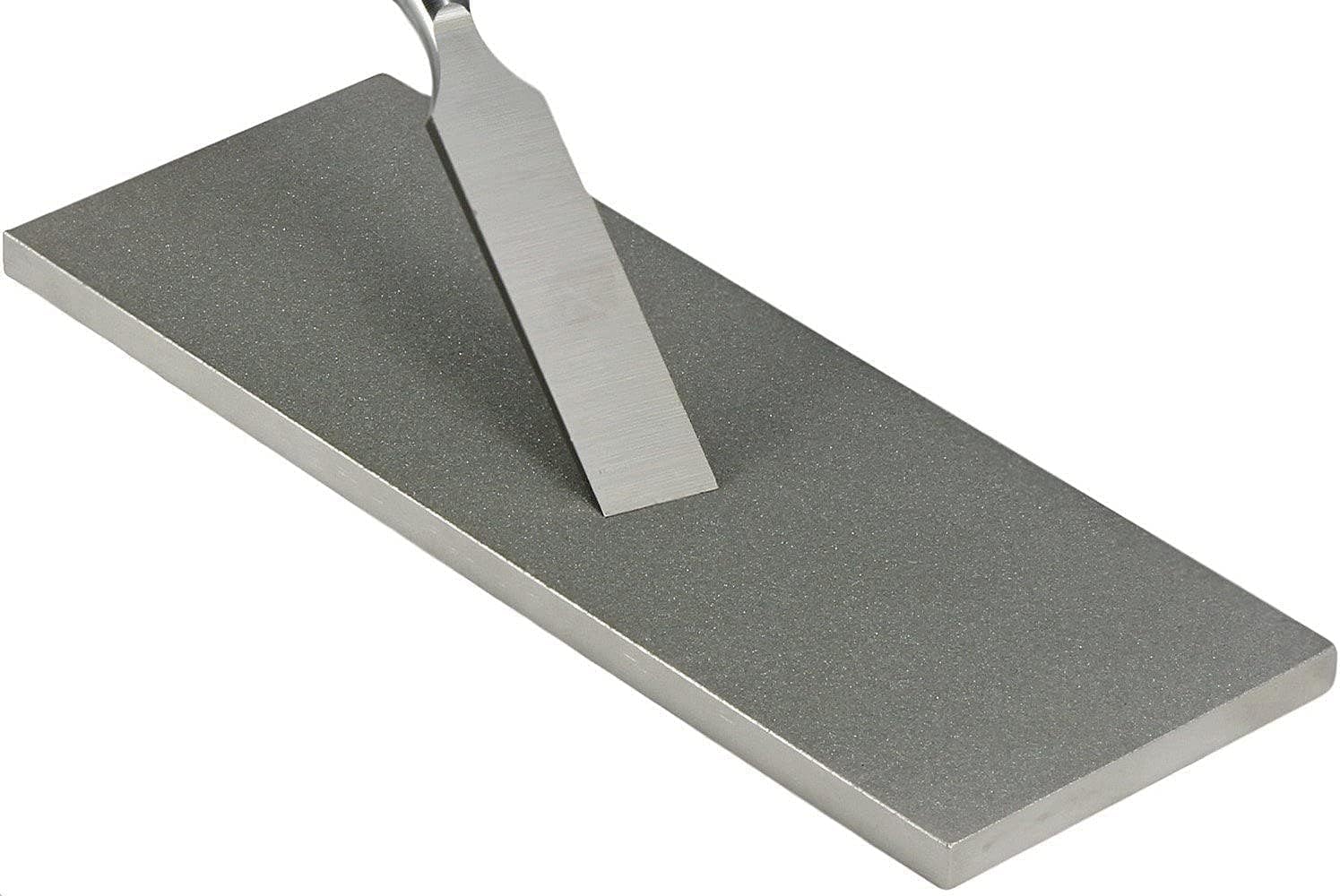 A chisel being sharpened on a diamond stone