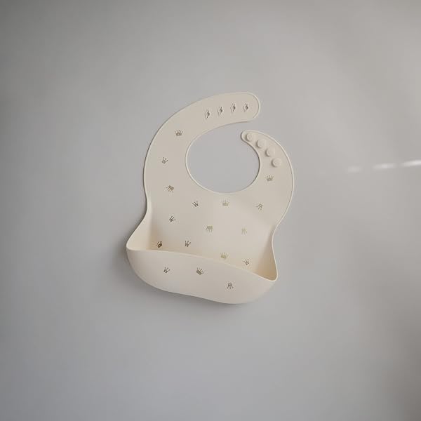Close-up of the Mushie Baby Silicone Bib's deep front pocket designed to catch dropped food.