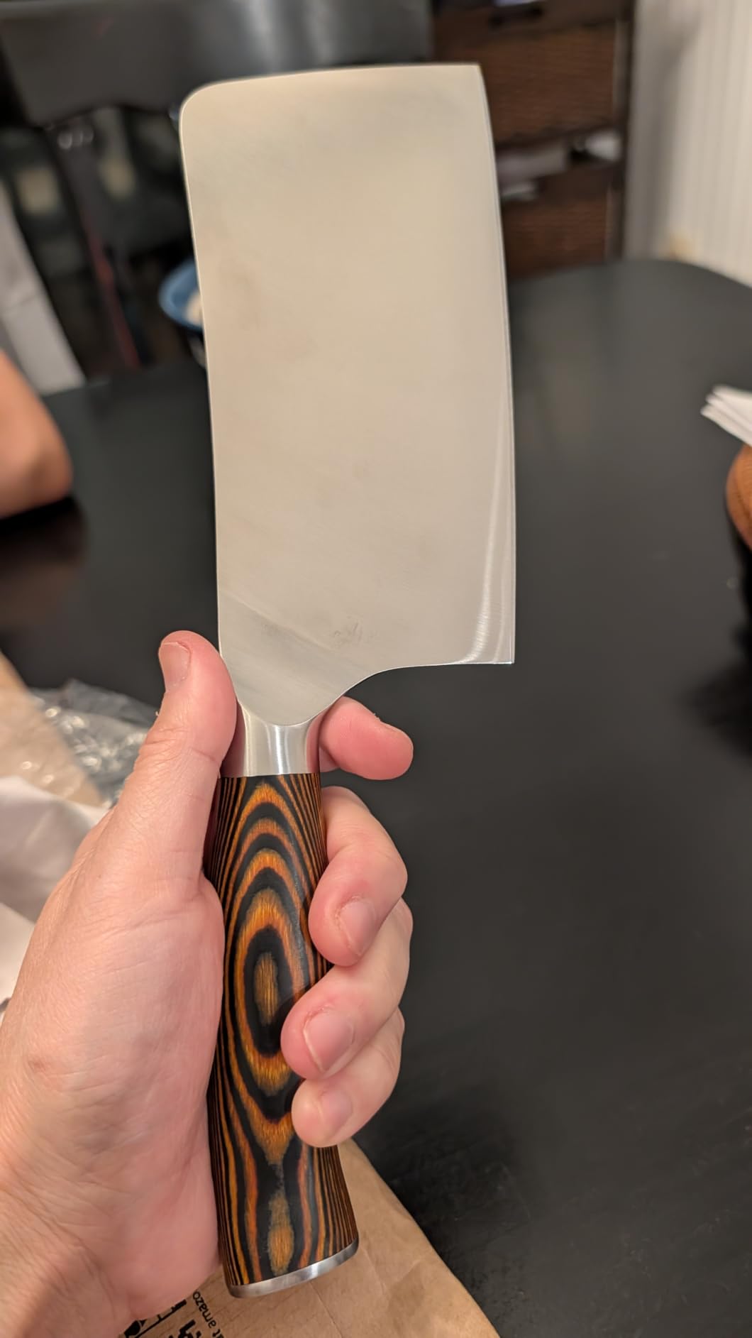 TUO chef knife on a wooden cutting board