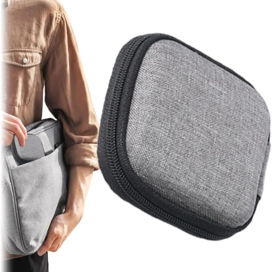 A person placing an MPM Charger and Cable Hard Travel Case into a gray backpack or bag.