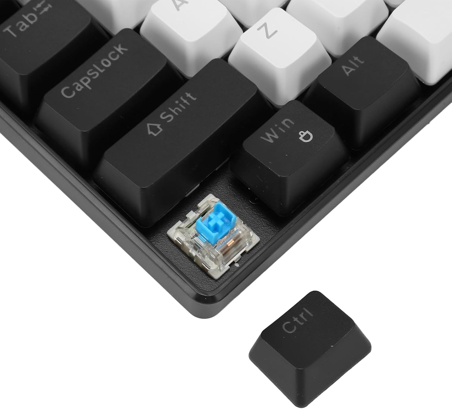 Close-up of a mechanical switch removed from the keyboard, next to a keycap, demonstrating the hot-swappable feature.