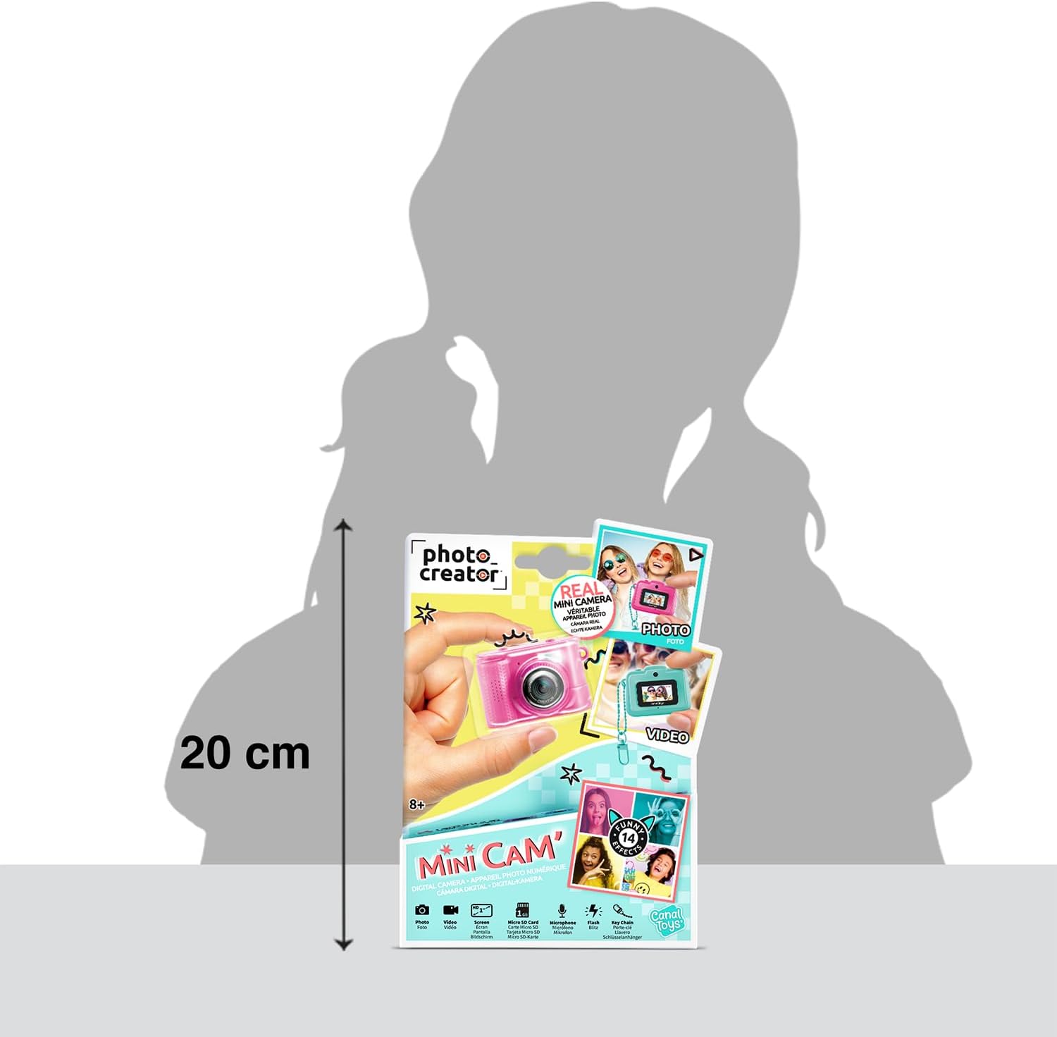 Contents of the Canal Toys Photo Creator Mini Digicam package, including the pink camera, a teal keychain, a 1GB Micro SD card, and a white USB-C charging cable.