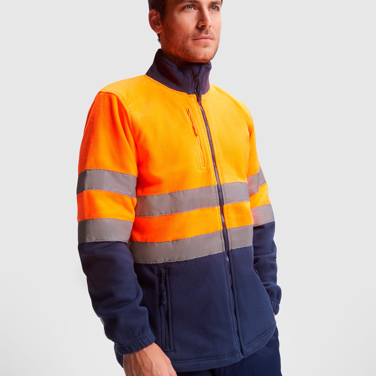 Chaqueta polar alta visibilidad adulto con cintas reflectantes, cremallera completa, bolsillos frontales y pecho, 100% poliéster