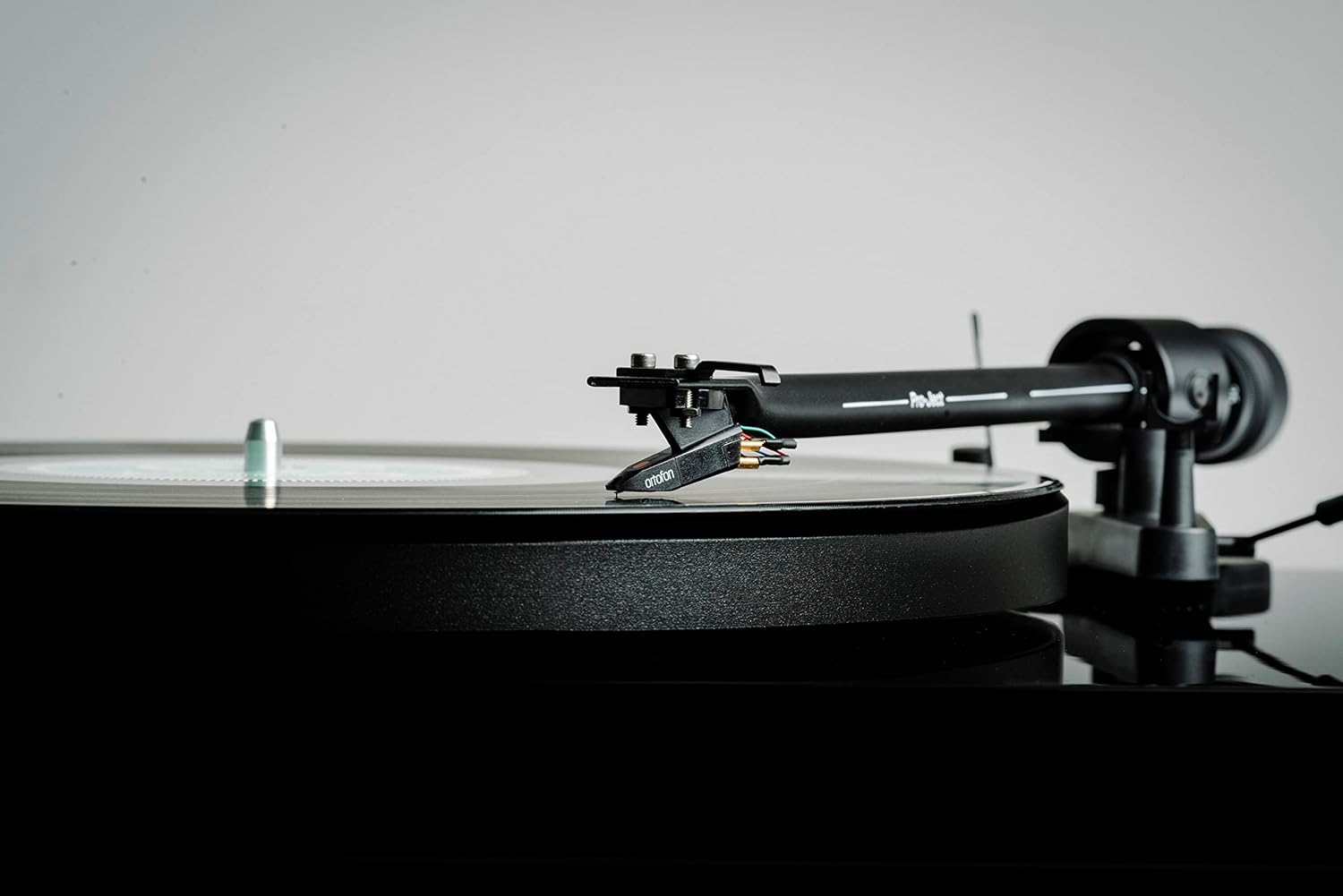 Close-up of the Ortofon OM5e cartridge playing a record