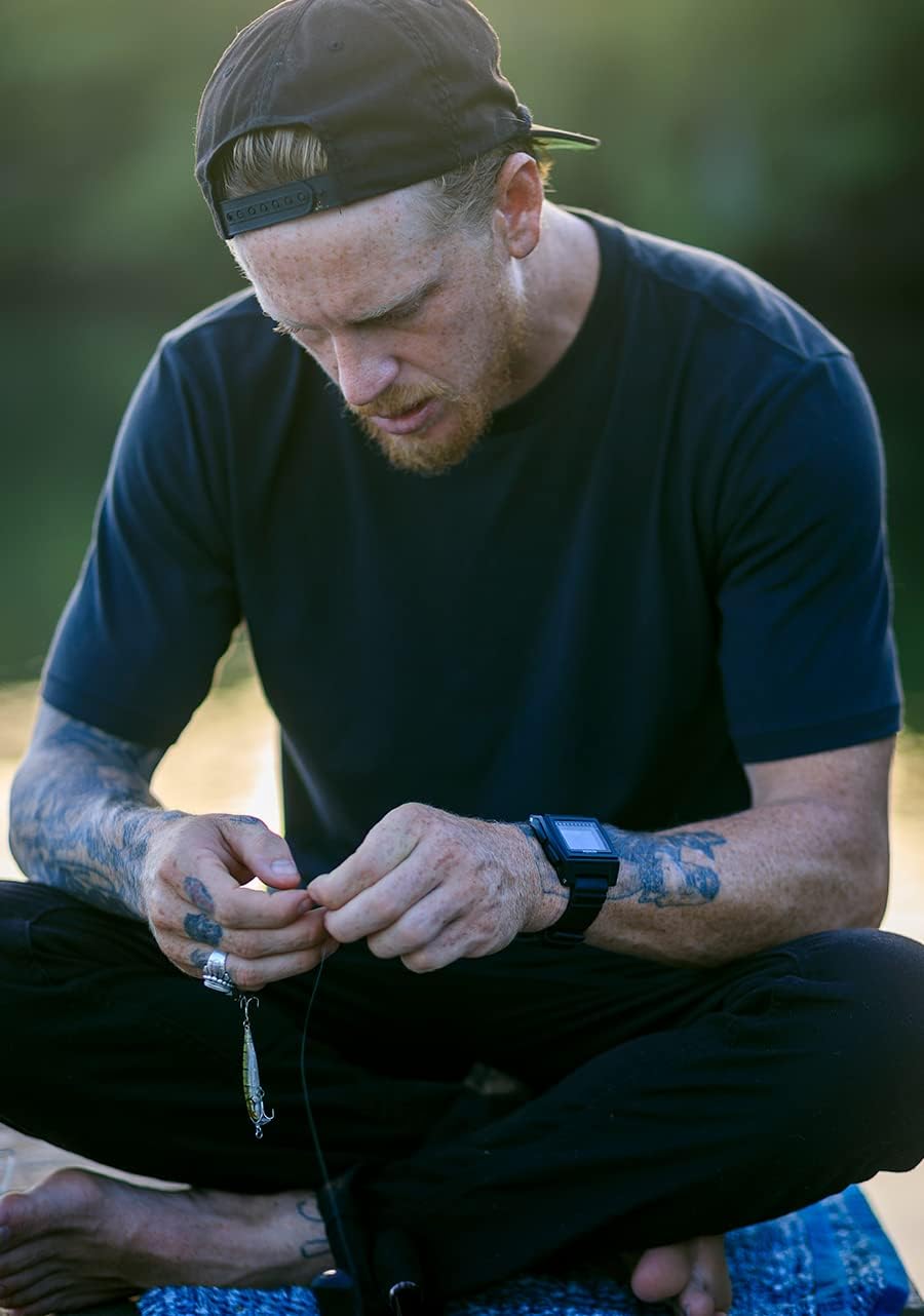 Person wearing NIXON Base Tide Pro watch while fishing