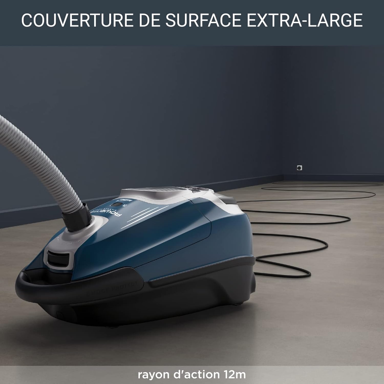 The vacuum cleaner with its power cord extended across a large room, demonstrating its 12-meter action radius.