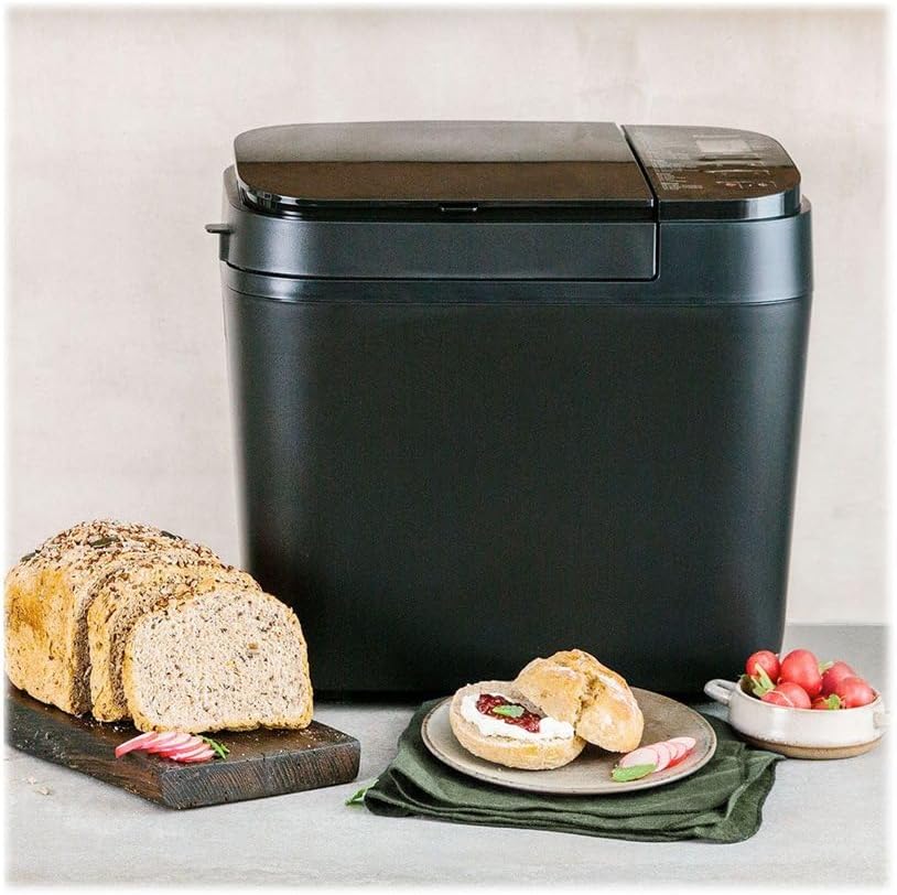 Freshly baked bread next to the Panasonic SD-R2530 bread maker