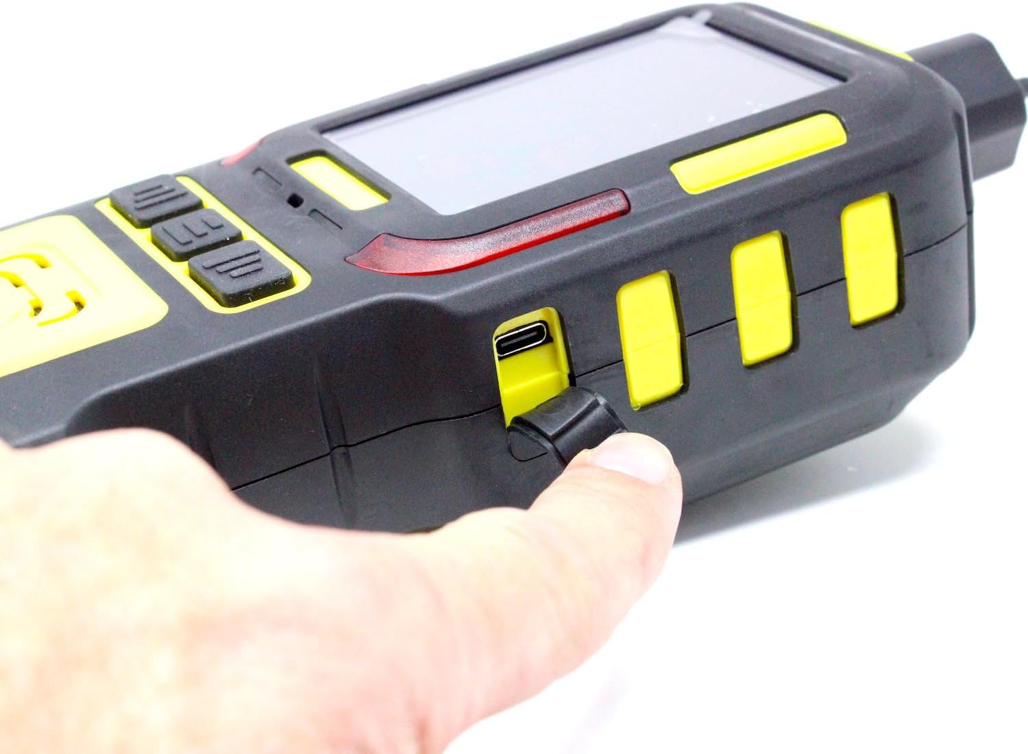 Close-up of a finger opening the protective cover of the USB-C charging port on the side of the FD-600M-H2S device.