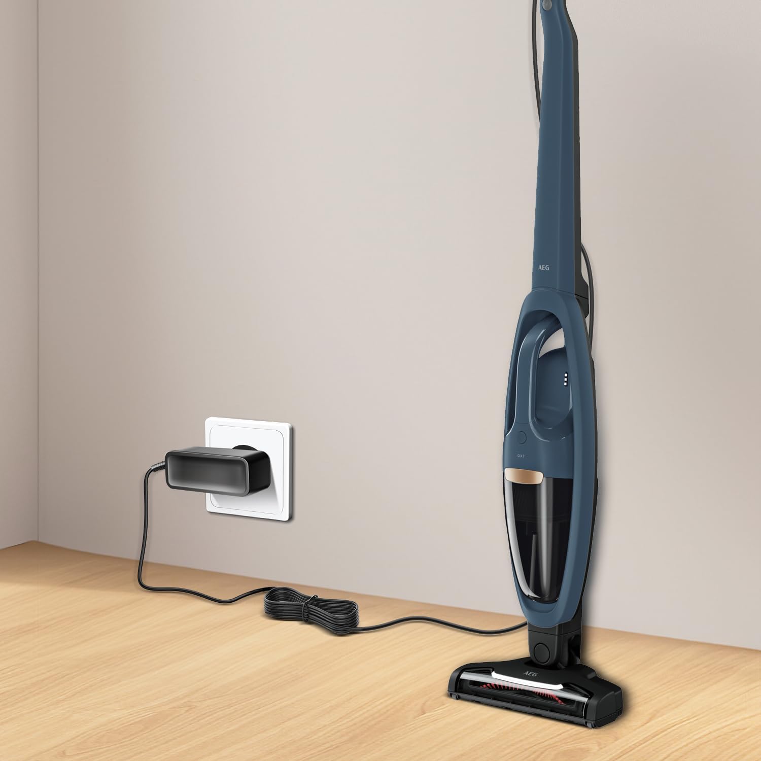 An AEG cordless vacuum cleaner plugged into a wall outlet via the KFD power adapter, illustrating a typical charging setup.