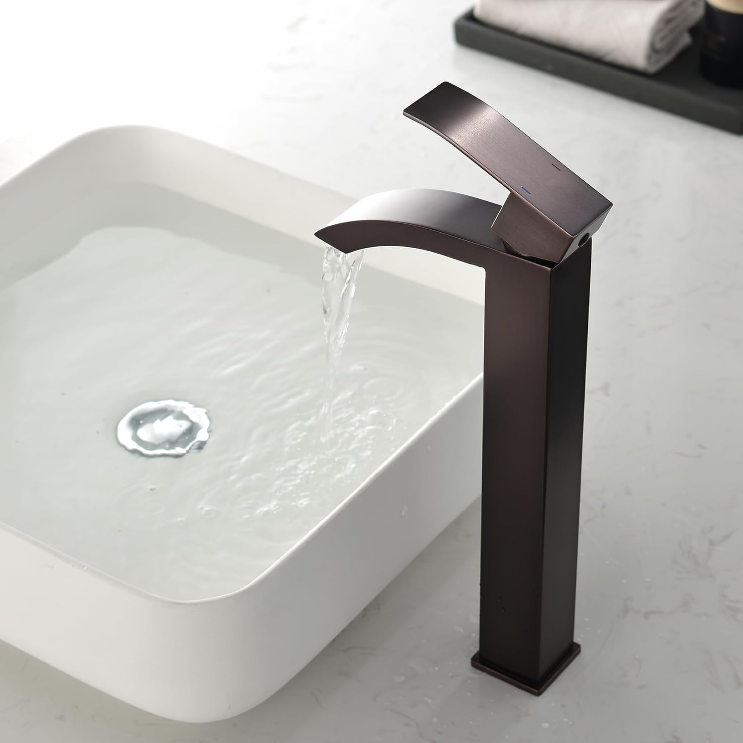 WELLFOR waterfall faucet installed on a bathroom sink with water flowing