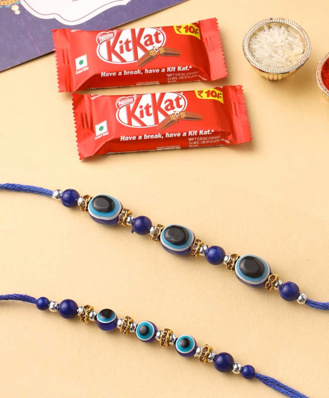CraftVatika Evil Eye Bracelet Rakhi Gift for Brother with Chocolate Combo - Set of 2 Rakhis Blue Evil Eye Rakhi for Boy Men with Chocolates and Greeting Card (B0B58XMT92) Amazon Price History, Amazon Price Tracker