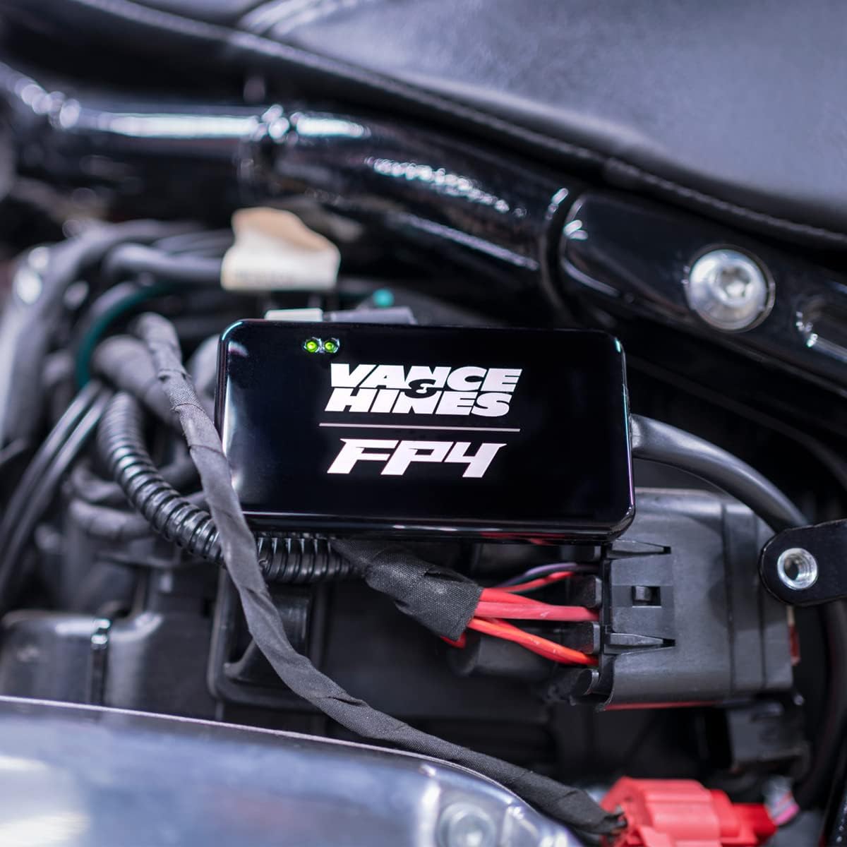 Close-up of the FP4 device connected to motorcycle wiring