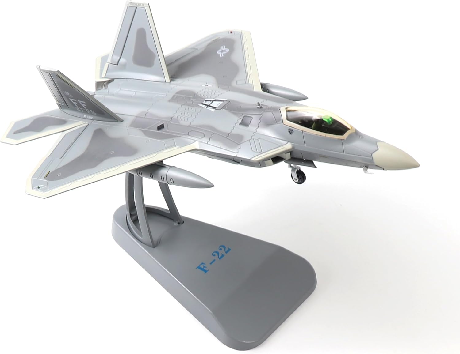 The F-22 Raptor model displayed on its included metal stand.