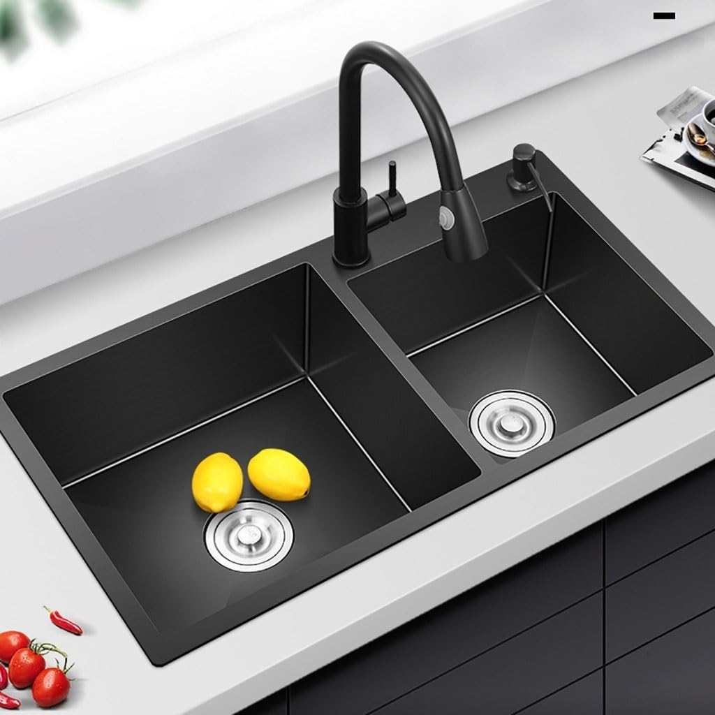 Black double bowl kitchen sink installed in a kitchen countertop with a black faucet and lemons in the bowls.