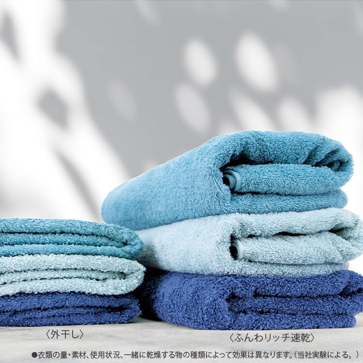 Stack of freshly washed and dried fluffy towels, demonstrating the quality of laundry results.