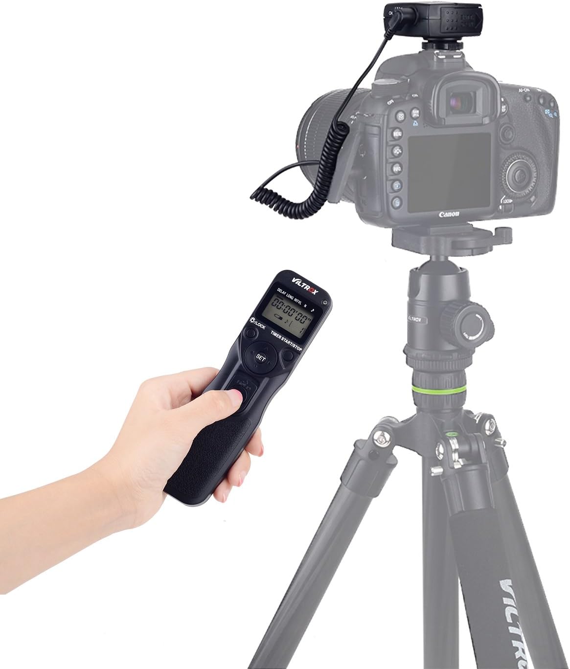 User holding the VILTROX JY-710-S2 transmitter wirelessly controlling a camera on a tripod