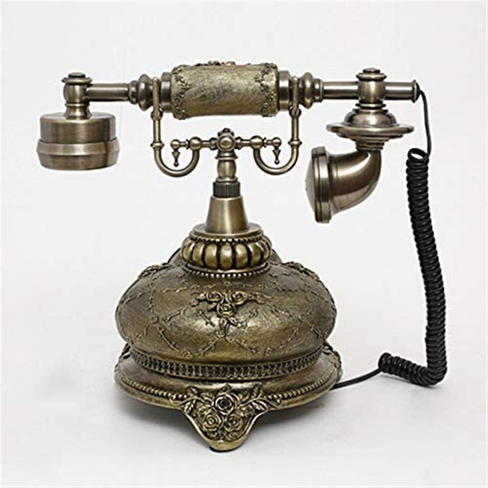 Telefon retro, replika telefonu zabytkowego, telefon stacjonarny retro, przewodowy, złoty, modny telefon z lat 60. z klasycznym obrotowym wybieraniem numerów.