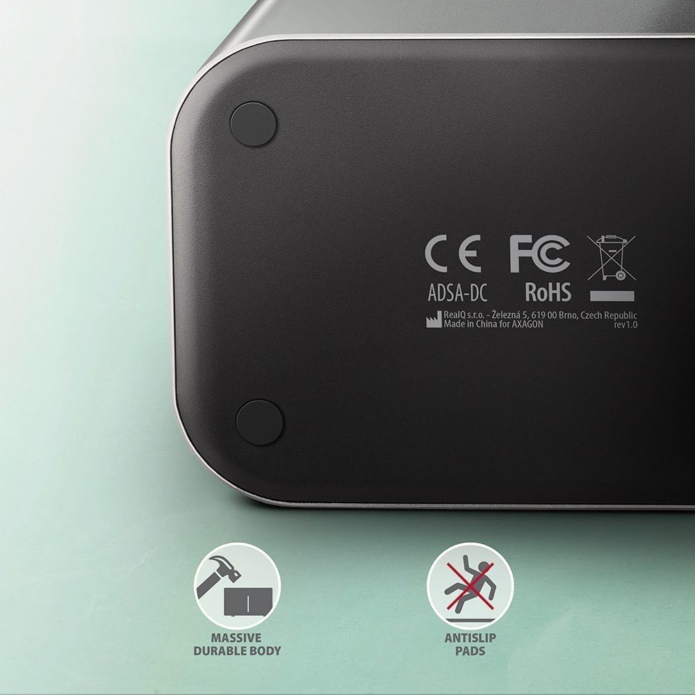 Handapeun view of the AXAGON ADSA-DC dock station, highlighting its massive durable body and anti-slip pads for stability.