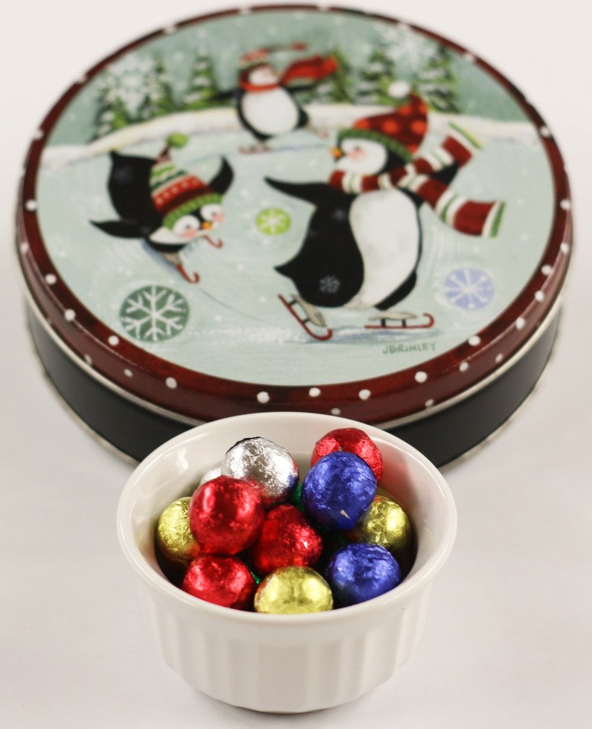 Scott's Cakes Foil Wrapped Solid Milk Chocolate Crisp Christmas Ornaments in a Small Skating Penguins Tin