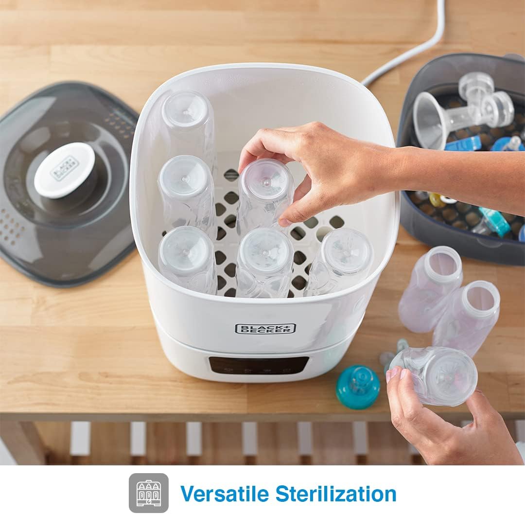 Hand placing bottles into the sterilizer's tall basket
