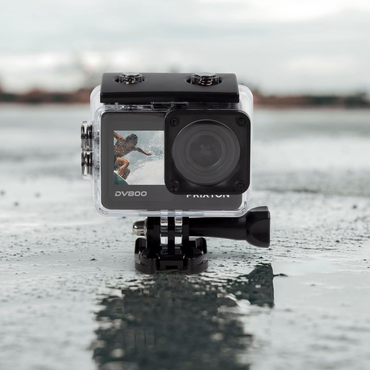 PRIXTON DV800 Action Camera enclosed in its transparent waterproof case, resting on a wet surface.