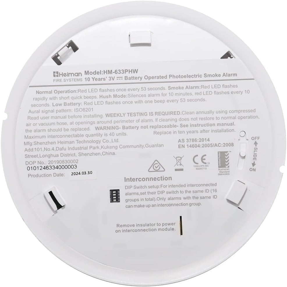 Close-up of the back of the smoke alarm showing the DIP switches for interconnection settings.