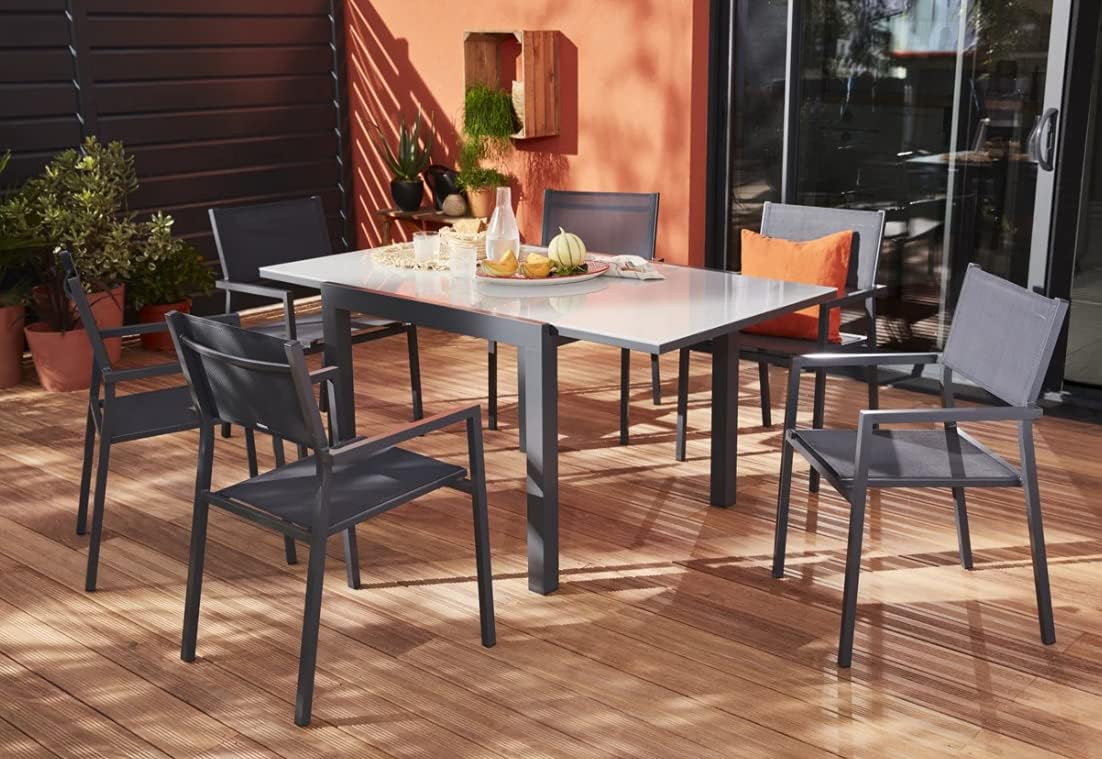 NATERIAL LYRA Extendable Garden Table in an outdoor setting, extended with chairs
