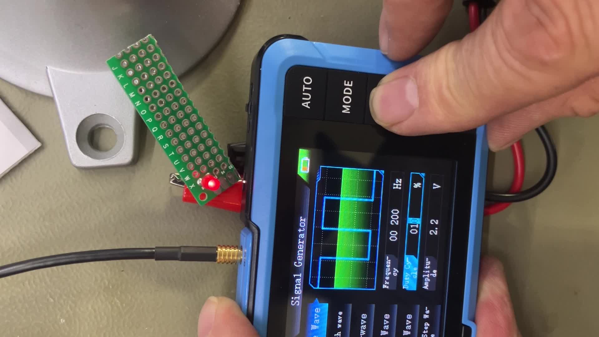 An overhead view of the FNRSI DSO-510 and its accessories laid out, including the main unit, oscilloscope probe, signal generator cables, USB cable, and the instruction manual.