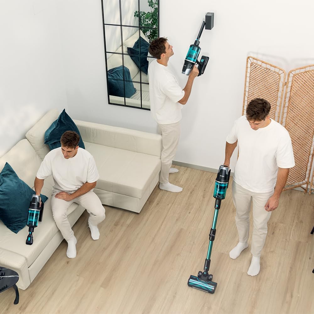 A person placing the Cecotec Conga Rockstar 9500 Lunar Pet Flex vacuum cleaner onto its wall-mounted charging station