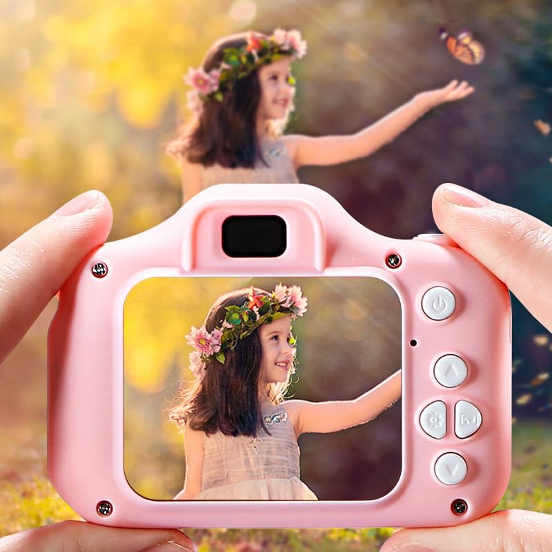 A child's hands holding a pink Smart Playground KidsCam, with the screen displaying a selfie of a child wearing a flower crown.