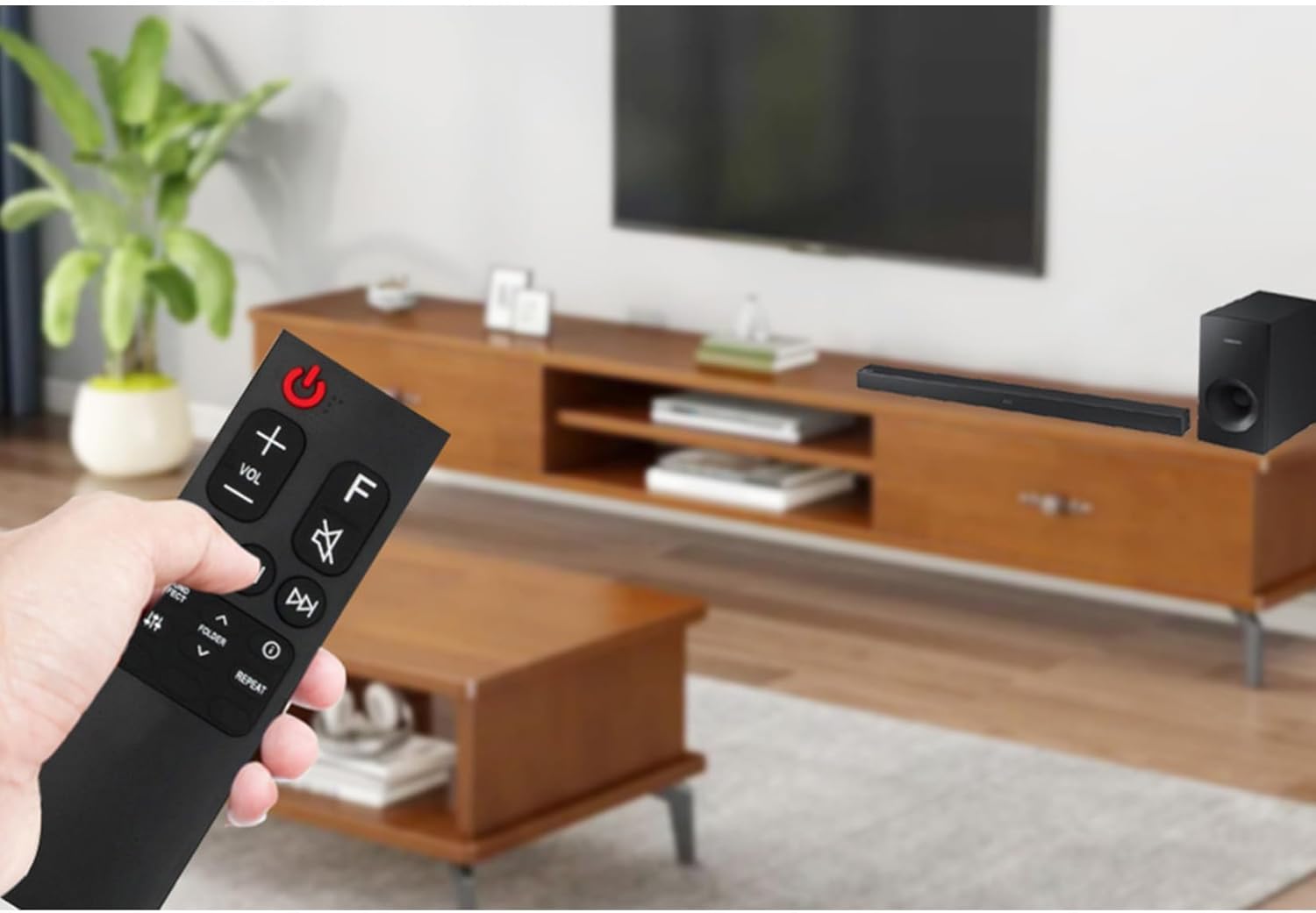 Person using the remote control with a sound bar setup