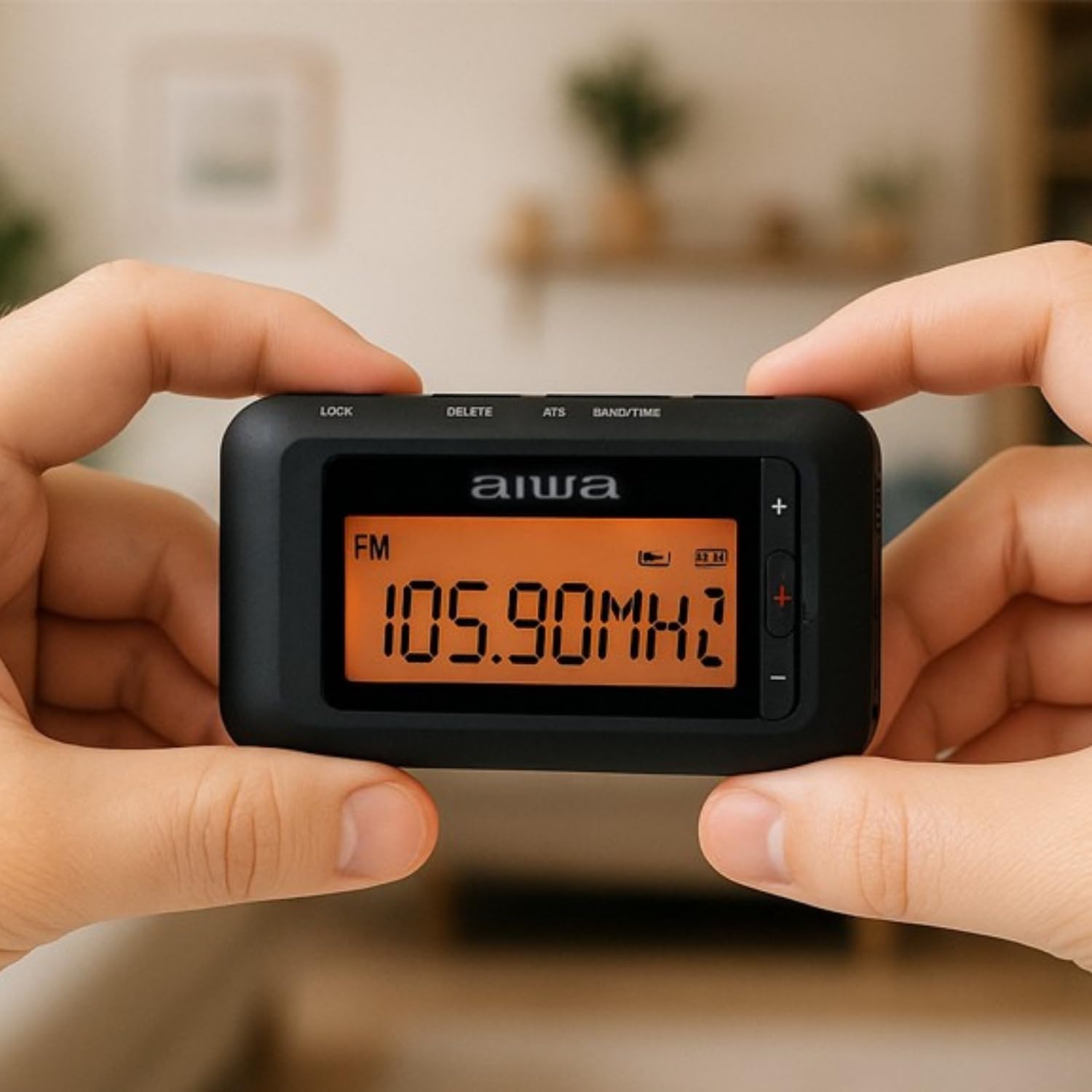 Hands holding AIWA RD-10 radio displaying FM frequency 105.90MHz