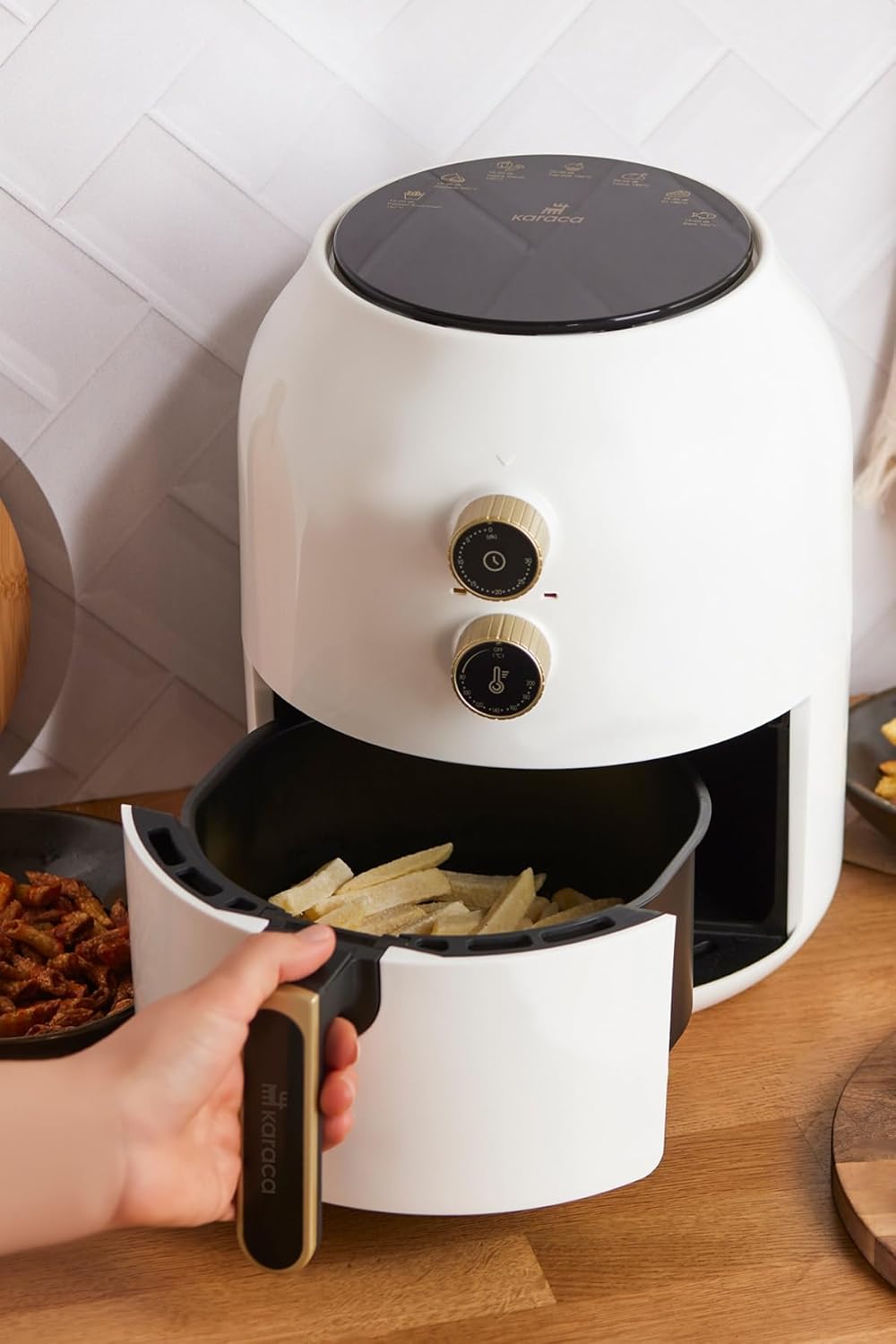 Air fryer with basket pulled out, showing fries inside