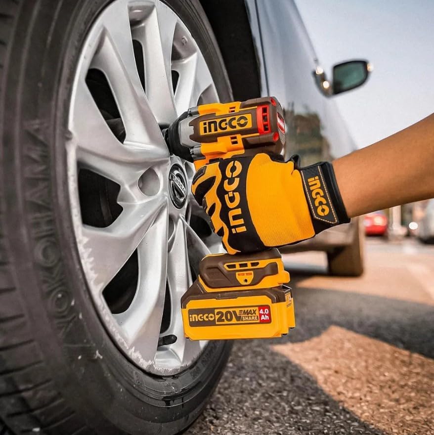 A person using the INGCO CIWLI2050 impact wrench to tighten a lug nut on a car wheel.