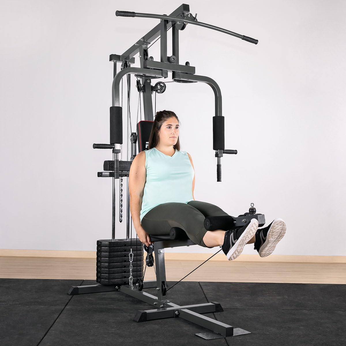 User performing leg extension on GYM-100