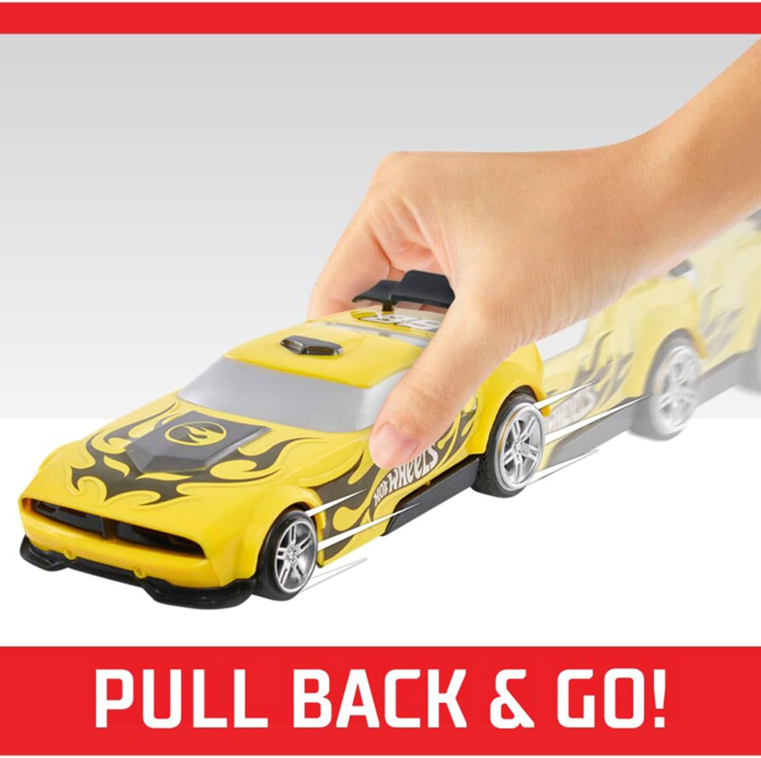 A hand pulling back a yellow Hot Wheels Fast Racer car on a track, demonstrating the pullback mechanism.
