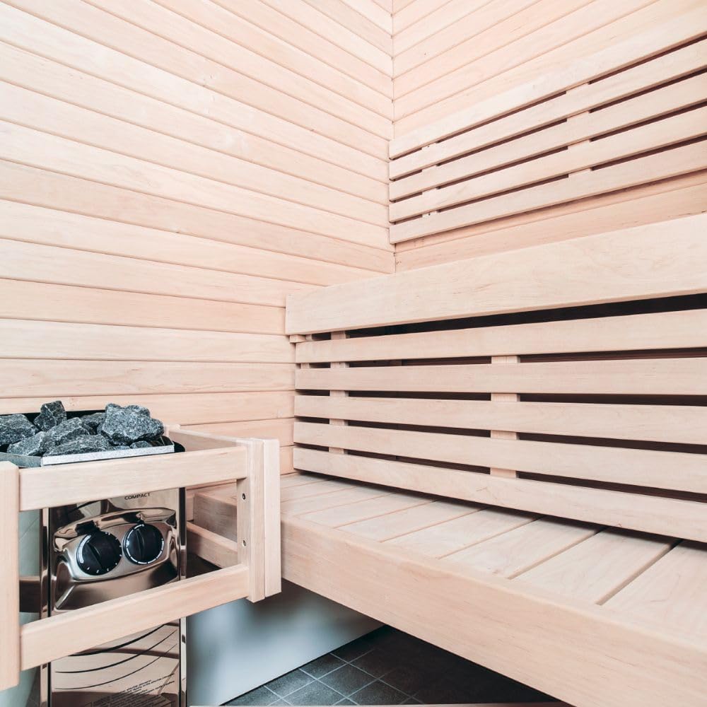 Escalfador de sauna compacte Harvia Vega integrat en una sala de sauna amb bancs i parets de fusta.